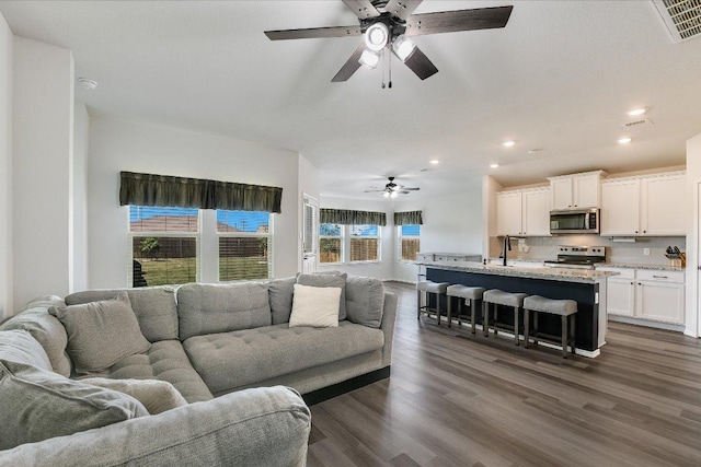 102 Reagor Dr, Taylor, TX 76574 - living room with ceiling fan, recessed lighting, and dark wood finished floors