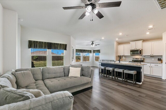 102 Reagor Dr, Taylor, TX 76574 - living room with ceiling fan, recessed lighting, and dark wood finished floors