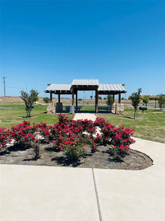 view of property's community with a gazebo and a yard