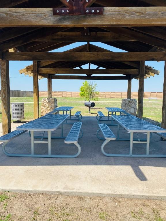 view of property's community featuring a gazebo, a yard, and fence