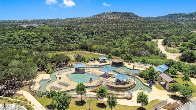 308 Rustling Wake Cv, Lakeway, TX 78738 - drone / aerial view of a heavily wooded area, a pool, and mountains