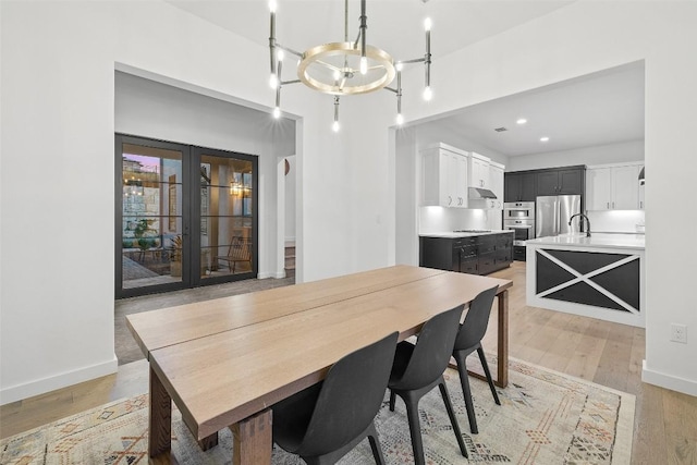 308 Rustling Wake Cv, Lakeway, TX 78738 - dining space featuring a chandelier, french doors, light wood finished floors, and recessed lighting