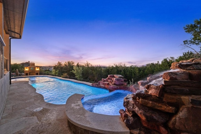 16216 Zagros Way, Austin, TX 78738 - pool at dusk featuring a pool with connected hot tub