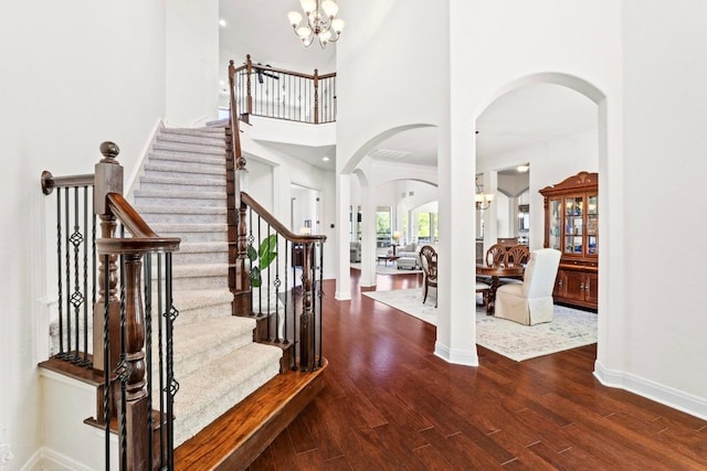 16216 Zagros Way, Austin, TX 78738 - entrance foyer featuring arched walkways, a chandelier, wood finished floors, and stairway