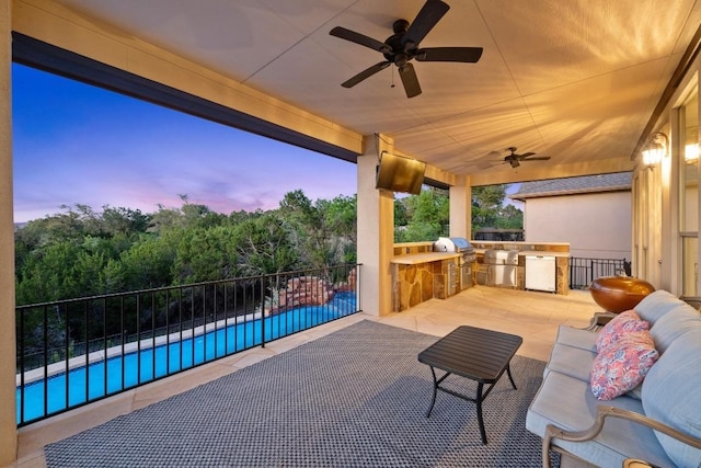 16216 Zagros Way, Austin, TX 78738 - patio terrace at dusk featuring an outdoor kitchen, ceiling fan, and a patio