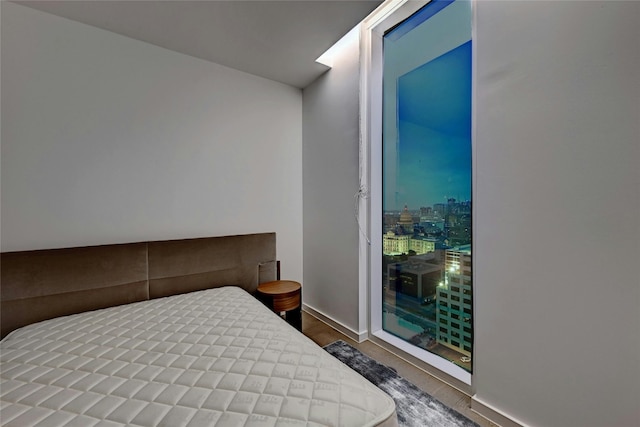 313 W 17th St Unit 2406, Austin, TX 78701 - bedroom with baseboards and wood finished floors