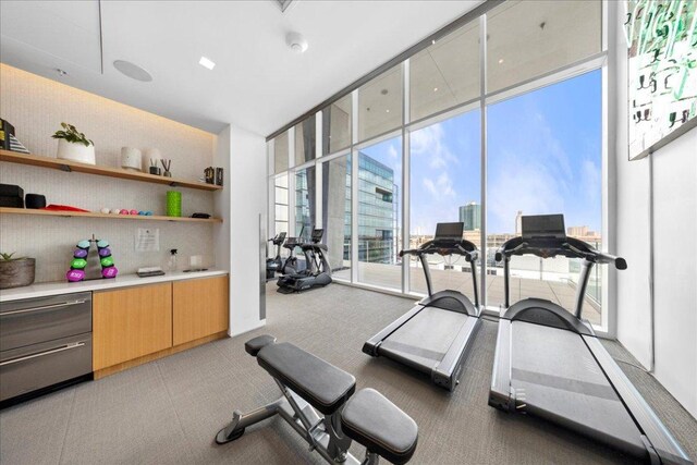 313 W 17th St Unit 2406, Austin, TX 78701 - workout area with floor to ceiling windows and light colored carpet