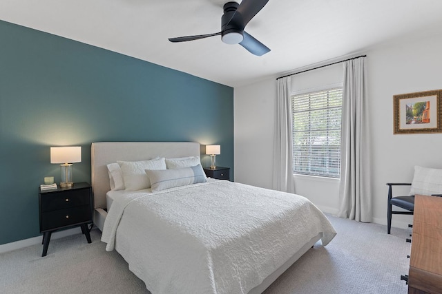 carpeted bedroom featuring baseboards and ceiling fan