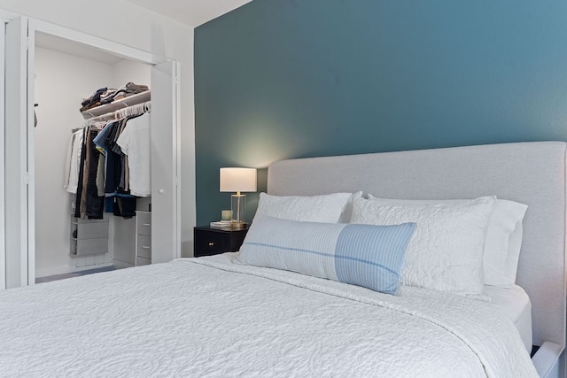 bedroom with a spacious closet and a closet
