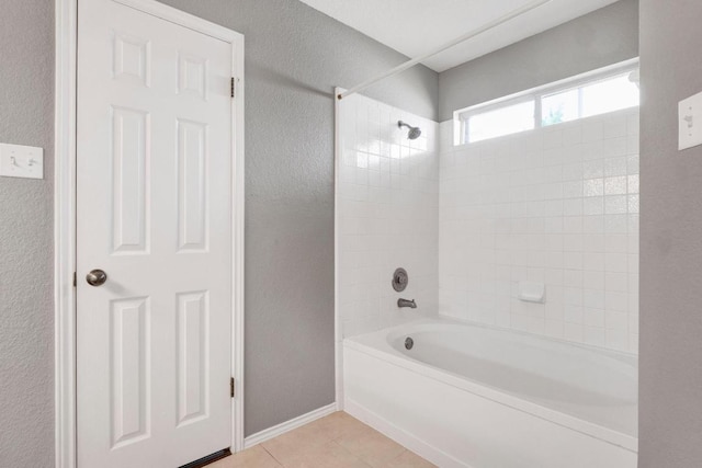 1415 Quicksilver Cir, Round Rock, TX 78665 - full bath featuring a textured wall,  shower combination, tile patterned flooring, and baseboards