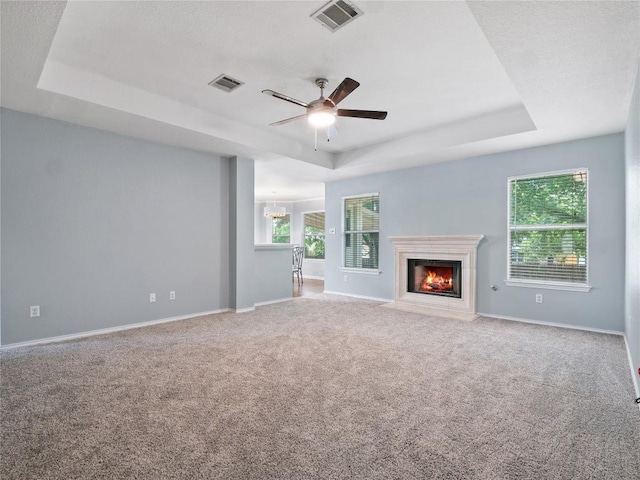 1415 Quicksilver Cir, Round Rock, TX 78665 - unfurnished living room featuring a raised ceiling, ceiling fan, baseboards, and carpet flooring