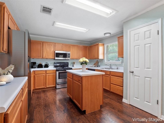 1415 Quicksilver Cir, Round Rock, TX 78665 - kitchen featuring appliances with stainless steel finishes, a sink, crown molding, light countertops, and dark wood-type flooring