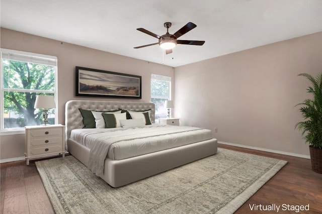 1415 Quicksilver Cir, Round Rock, TX 78665 - bedroom featuring baseboards, dark wood-style flooring, and a ceiling fan