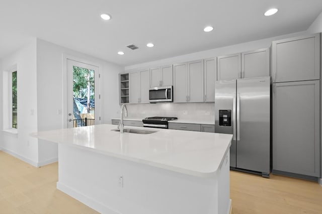 5107 Menchaca Rd Unit 9, Austin, TX 78745 - kitchen with appliances with stainless steel finishes, gray cabinets, light wood-type flooring, recessed lighting, and backsplash