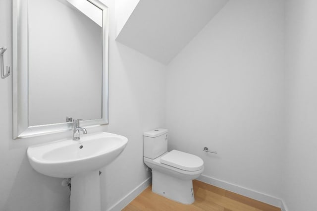5107 Menchaca Rd Unit 9, Austin, TX 78745 - half bathroom with wood finished floors and vaulted ceiling