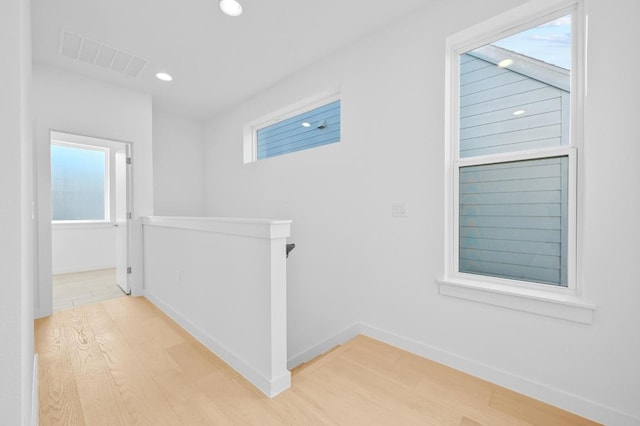 5107 Menchaca Rd Unit 9, Austin, TX 78745 - hall with an upstairs landing, light wood finished floors, and recessed lighting