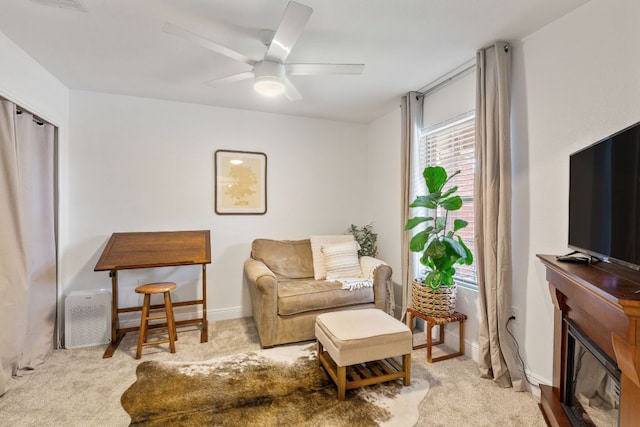 12616 Sky Harbor Dr, Del Valle, TX 78617 - carpeted living room with a glass covered fireplace and ceiling fan