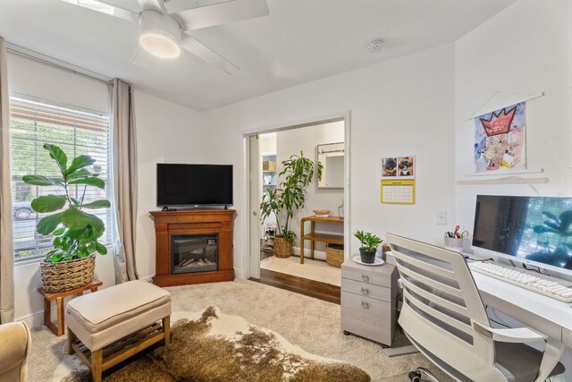 12616 Sky Harbor Dr, Del Valle, TX 78617 - living room featuring a ceiling fan and a glass covered fireplace