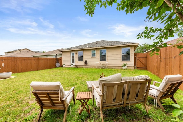 12616 Sky Harbor Dr, Del Valle, TX 78617 - back of house featuring a gate, a yard, roof with shingles, and a fenced backyard