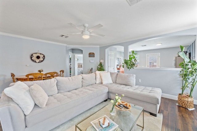 12616 Sky Harbor Dr, Del Valle, TX 78617 - living area featuring a ceiling fan, crown molding, wood finished floors, arched walkways, and visible vents