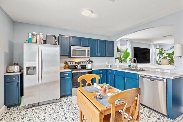 12616 Sky Harbor Dr, Del Valle, TX 78617 - kitchen with light countertops, blue cabinetry, stainless steel appliances, and a sink