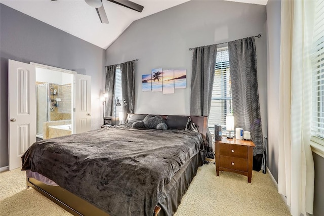 bedroom with light carpet, vaulted ceiling, ensuite bathroom, and a ceiling fan