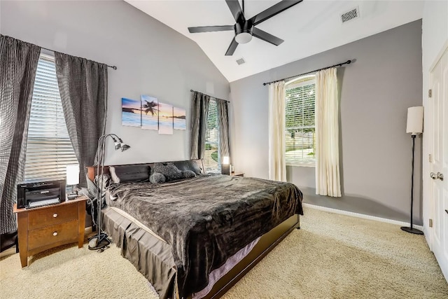 carpeted bedroom featuring lofted ceiling, visible vents, a ceiling fan, and baseboards
