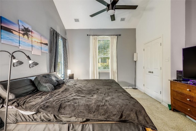 carpeted bedroom featuring vaulted ceiling, visible vents, and ceiling fan