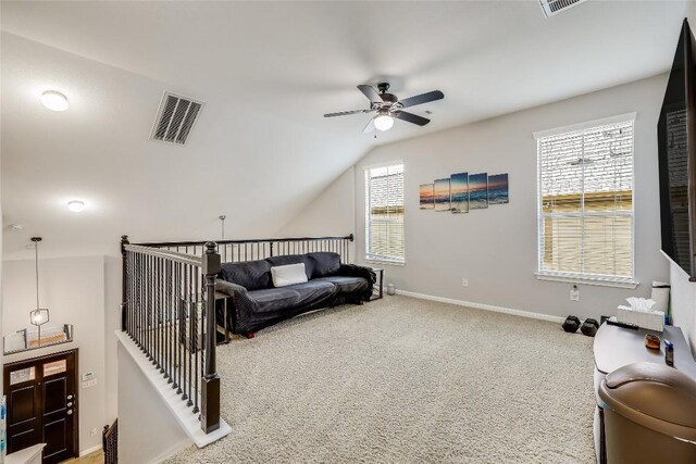 living area with carpet, lofted ceiling, visible vents, baseboards, and ceiling fan
