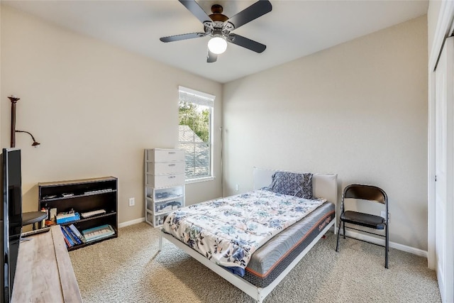 bedroom with baseboards, a ceiling fan, and carpet