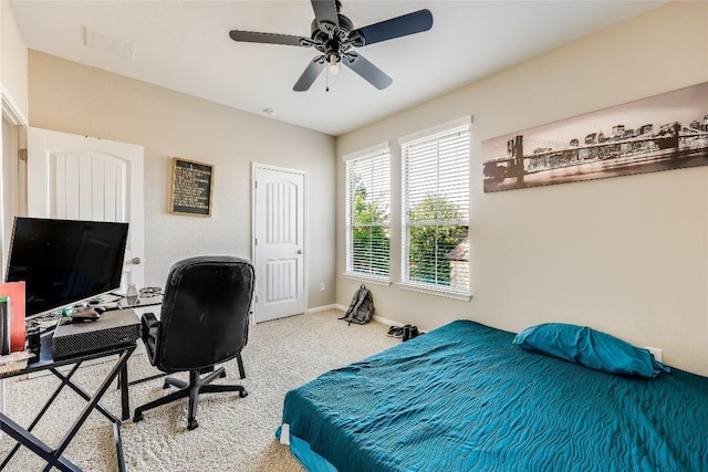 carpeted bedroom featuring visible vents, a ceiling fan, and baseboards