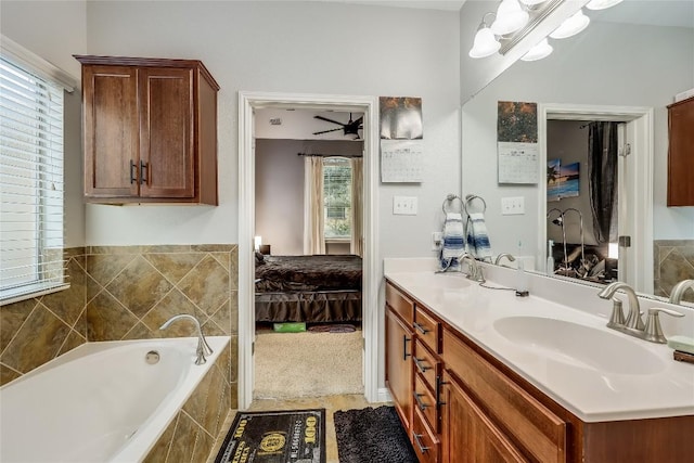 ensuite bathroom with a bath, ensuite bath, a sink, and double vanity