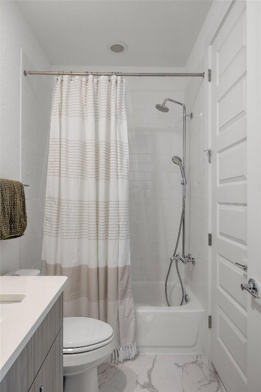 5368 Agatha Cir, Austin, TX 78724 - bathroom with marble finish floors, toilet, shower / bath combo with shower curtain, and vanity