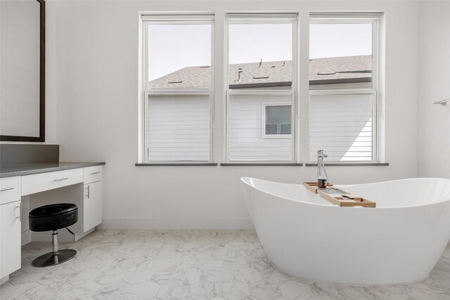 5368 Agatha Cir, Austin, TX 78724 - bathroom featuring a freestanding bath, vanity, and marble look tile flooring