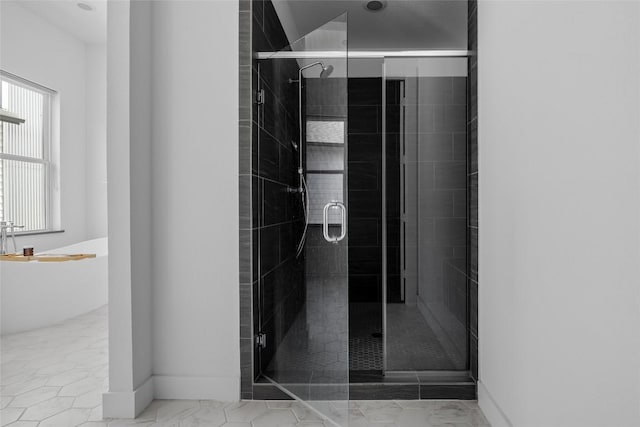 5368 Agatha Cir, Austin, TX 78724 - full bath featuring a freestanding tub, a stall shower, baseboards, and marble look tile flooring
