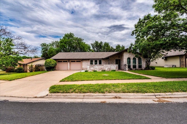 9011 W Pointer Ln, Austin, TX 78758 - view of front of property with a garage, driveway, a front yard, and brick siding