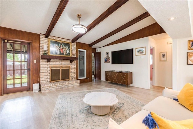9011 W Pointer Ln, Austin, TX 78758 - living room with wooden walls, wood finished floors, and a fireplace