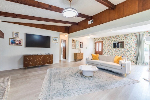 9011 W Pointer Ln, Austin, TX 78758 - living area with light wood-style flooring, beam ceiling, wallpapered walls, and plenty of natural light