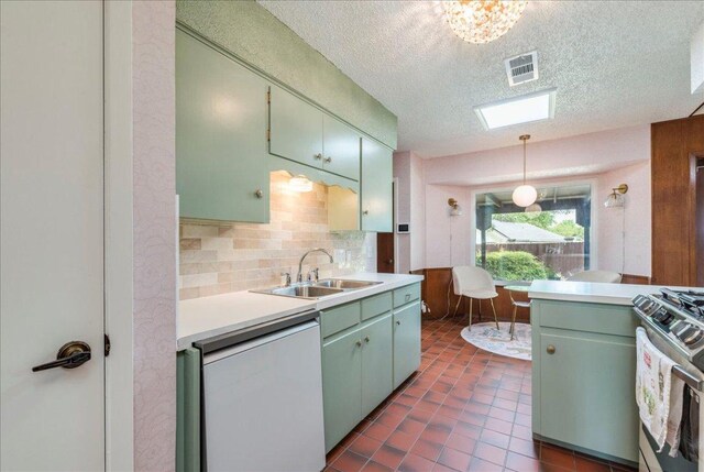 9011 W Pointer Ln, Austin, TX 78758 - kitchen with stainless steel range with gas stovetop, light countertops, a sink, decorative backsplash, and a textured ceiling