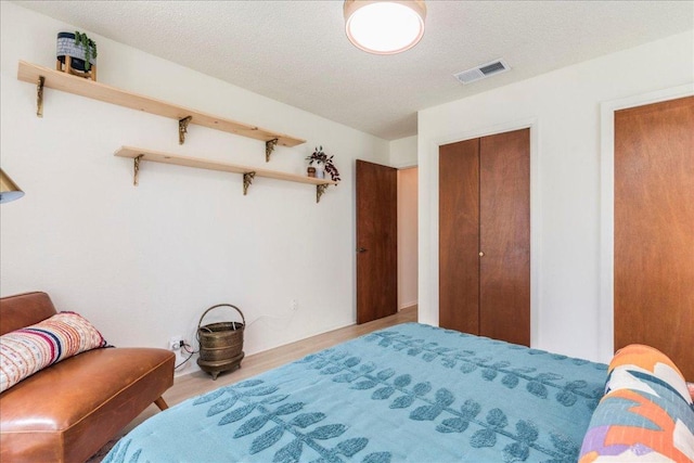 9011 W Pointer Ln, Austin, TX 78758 - bedroom featuring wood finished floors and a closet
