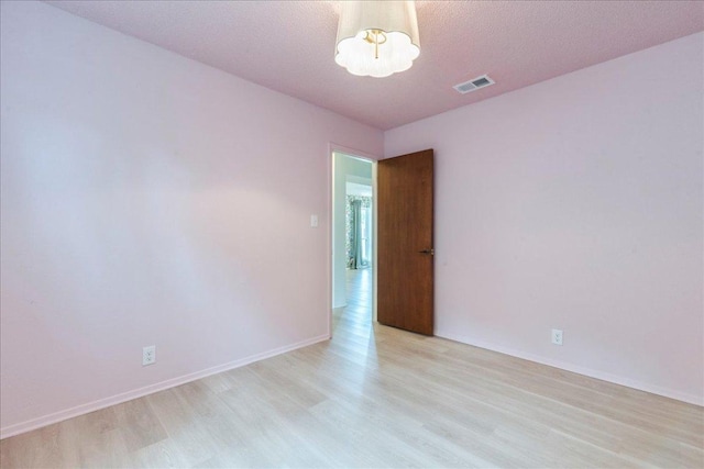 9011 W Pointer Ln, Austin, TX 78758 - spare room with light wood-style flooring and baseboards