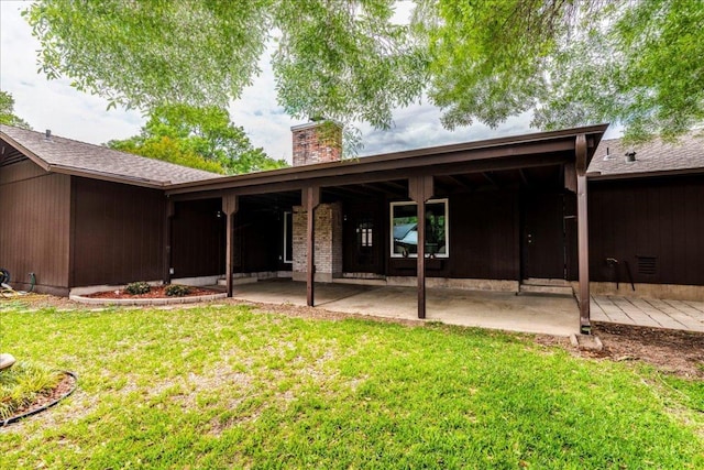 9011 W Pointer Ln, Austin, TX 78758 - back of property with a chimney, a patio area, and a yard
