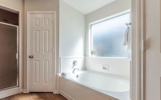 208 Bastian Ln, Georgetown, TX 78626 - full bath featuring a stall shower, a bath, and wood finished floors