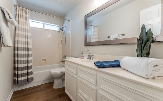 208 Bastian Ln, Georgetown, TX 78626 - bathroom with wood finished floors, shower / bath combo with shower curtain, vanity, and toilet