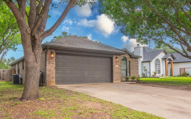 208 Bastian Ln, Georgetown, TX 78626 - view of front of property with brick siding, driveway, a garage, cooling unit, and a chimney