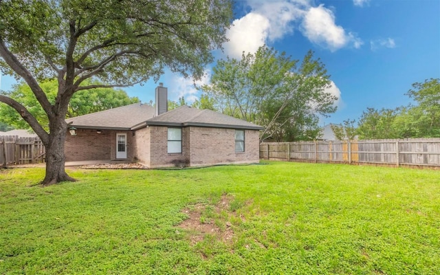 208 Bastian Ln, Georgetown, TX 78626 - rear view of property featuring a chimney and brick siding