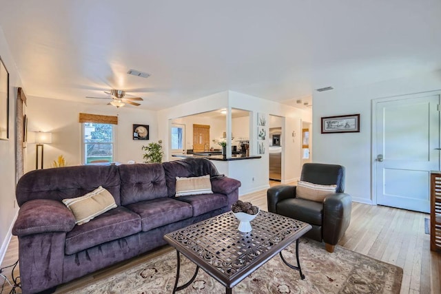 2102 E Martin Luther King Jr Blvd, Austin, TX 78702 - living room with light wood-style flooring, ceiling fan, and baseboards