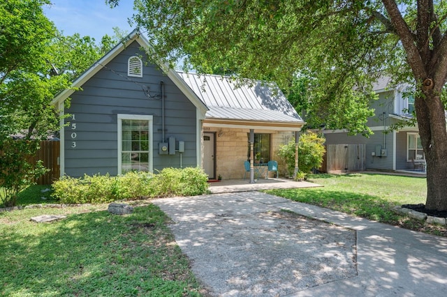 1503 Hart St, Georgetown, TX 78626 - view of front facade featuring a metal roof and a patio area