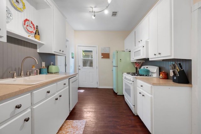 1503 Hart St, Georgetown, TX 78626 - kitchen with white appliances, a sink, light countertops, and dark wood finished floors