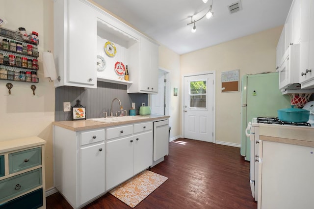 1503 Hart St, Georgetown, TX 78626 - kitchen with white appliances, dark wood-style floors, light countertops, and white cabinets